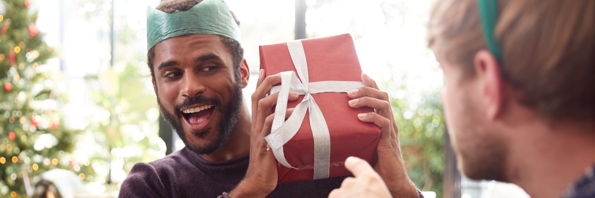 men exchanging christmas gifts