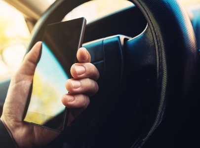 person using mobile phone when driving