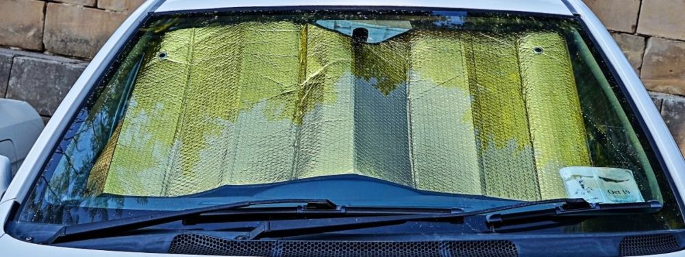 Use of a windscreen to block the sun from the car.