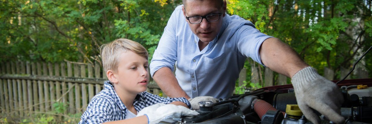 Man and son carrying out car checks