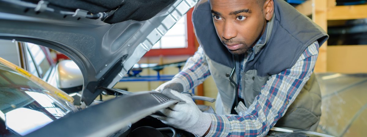 man checking under his bonnet