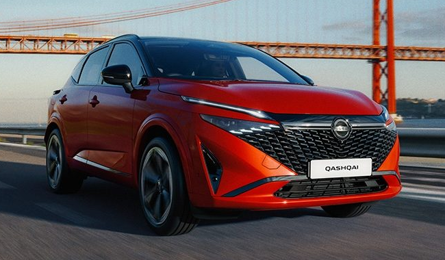 A red Nissan Qashqai pictured driving with a red bridge in the background - iconic cars