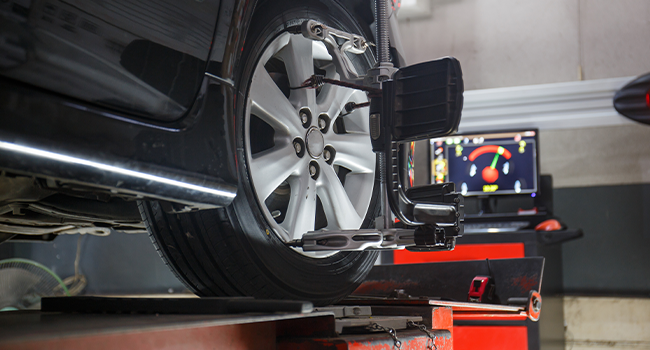 Wheel Alignment Problems: Car on stand with sensors on wheels for wheels alignment camber