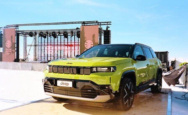 A Jeep with the Snow Sports League stage in the background 