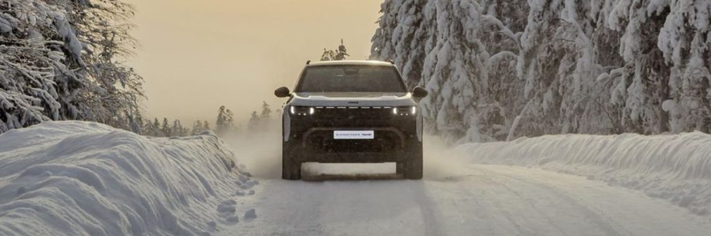 A Jeep effortlessly driving through the snow