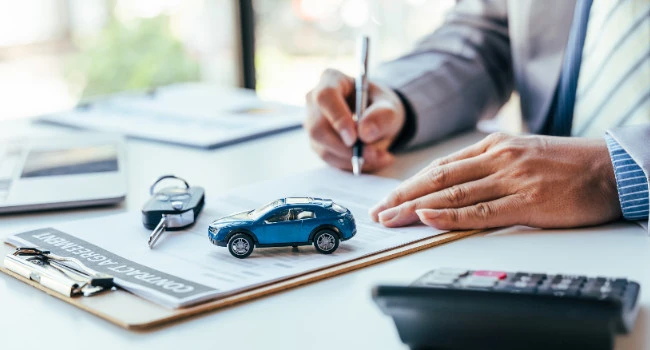 Signing a contract agreement in a dealership