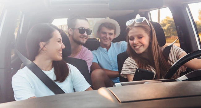 A car full with people on a trip